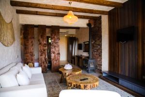 a living room with a white couch and a table at MAVİ AT HOTEL Blue Horse in Gümüşdere