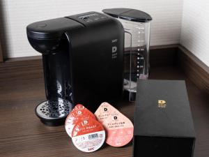 a black coffee maker and a box on a table at Premier Hotel - CABIN PRESIDENT - Hakodate in Hakodate