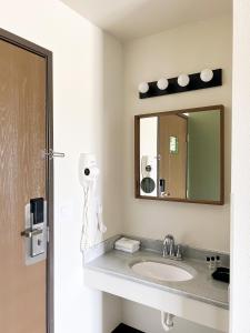 a bathroom with a sink and a mirror at The Trail Inn - Atlanta, Illinois - Route 66, I-55 in Atlanta