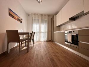 a kitchen and dining room with a table and chairs at NEW Duomo, Hospital, ENI - Cozy Home in San Donato Milanese
