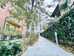 a sidewalk in front of a apartment building at NEW Duomo, Hospital, ENI - Cozy Home in San Donato Milanese