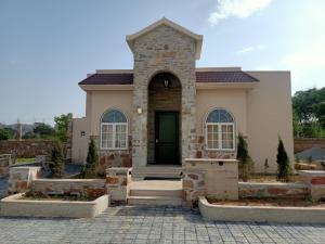 a house with a front entrance with a door at Riverarch Greenfields Resort in Chandwaji
