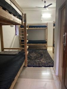 a room with two bunk beds and a ceiling at Nebula Nest Cafe & Hostel in Auroville