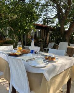 a table with plates of food and bottles of water at Agriturismo Tenuta la Monaca in Aradeo +53 photos