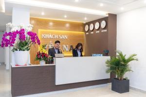 two people sitting at a counter in a lobby at Yen Nam Hotel Hoang Van Thu in Ho Chi Minh City