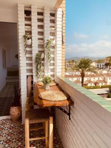 a table on a balcony with a view of a city at K-NAT by Nuka Homes in Platja de l'Arenal