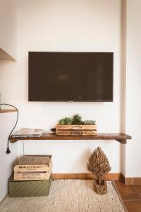 a living room with a tv on a wall at K-NAT by Nuka Homes in Platja de l'Arenal