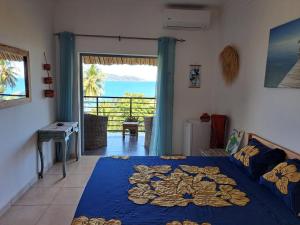 a bedroom with a bed and a view of the ocean at LE CHISSIOUA in Sada