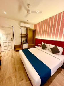 a bedroom with a large bed with a blue blanket at Hotel Mystic Falls in Jaipur