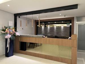 a lobby with a reception desk with a large screen at GRAND AROMAS in Kulai