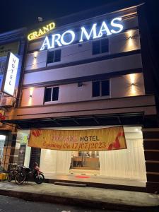 a store with a sign on the side of a building at GRAND AROMAS in Kulai