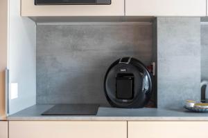 a black appliance sitting on top of a kitchen counter at Palanga Studios in Palanga