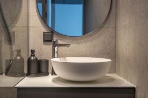 a bathroom with a bowl sink and a mirror at Palanga Studios in Palanga