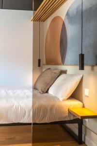 a bedroom with a bed and a yellow bench at Palanga Studios in Palanga