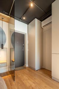 a room with glass walls and wood floors at Palanga Studios in Palanga