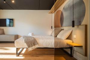 a bedroom with a bed and a couch at Palanga Studios in Palanga