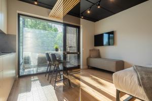 a bedroom with a bed and a table and a window at Palanga Studios in Palanga
