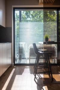 a kitchen with a table and a chair in front of a window at Palanga Studios in Palanga