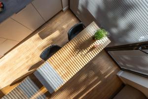 a table with chairs and a potted plant on it at Palanga Studios in Palanga