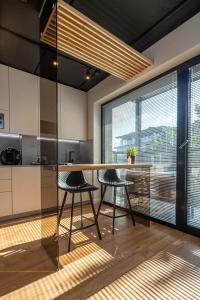 a kitchen with a table and two stools at Palanga Studios in Palanga
