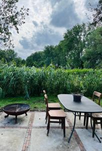 a patio with a table and chairs and a fire pit at HOMESTEAD Amsterdam in Amsterdam