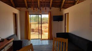 a living room with a couch and a sliding glass door at FLY FISHING PARADISE ON THE VAAL in Parys