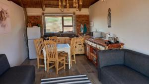 eine Küche und ein Esszimmer mit einem Tisch und Stühlen in der Unterkunft FLY FISHING PARADISE ON THE VAAL in Parys