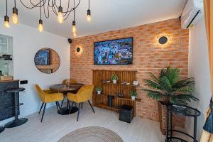 a room with a brick wall and a table and chairs at Holiday in Alba Iulia