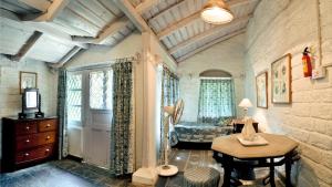 a room with a bedroom with a desk and a bed at Neemrana's - Ramgarh Bungalows in Rāmgarh