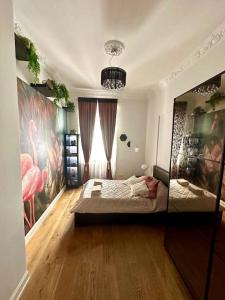 a bedroom with a bed and a painting of flamingos at Bay of Art in Trieste