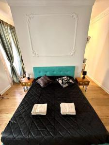 a bedroom with a bed with a black comforter at Bay of Art in Trieste