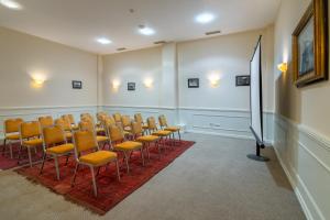 a conference room with chairs and a podium in it at GINGER Hotel in Tbilisi City