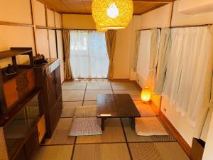 een woonkamer met een tafel en een raam bij ＡＴＴＡ ＨＯＴＥＬ ＫＡＭＡＫＵＲＡ - Vacation STAY 33593v in Kamakura