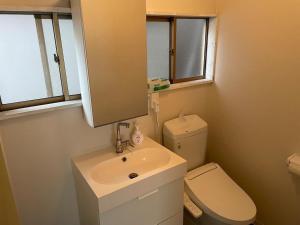 bagno con lavandino, servizi igienici e specchio di ＡＴＴＡ ＨＯＴＥＬ ＫＡＭＡＫＵＲＡ - Vacation STAY 63328v a Kamakura