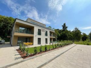 a building with a garden in front of it at Optimus Residence in Balatonföldvár