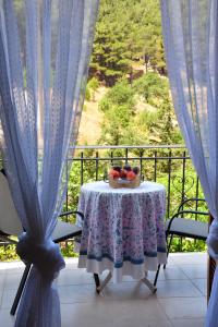 a table with a bowl of fruit on a balcony at Maro's house in Samothraki