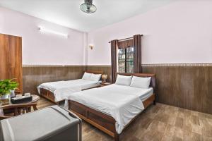 Postel nebo postele na pokoji v ubytování Mộc Nhiên Hotel Da Nang