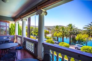 ケープタウンにあるCape Riviera Guesthouseの- 水とヤシの木の景色を望むバルコニー +22枚の写真