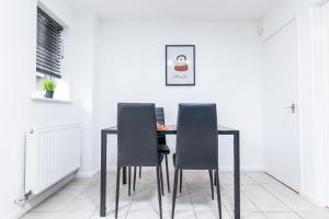 a dining room with a table and three chairs at Marham Close in Nottingham
