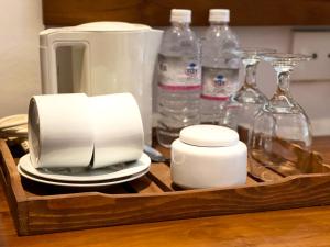 a tray with a toaster and plates and bottles of water at Grand Rockland Hotel in Matara