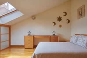 a bedroom with a bed and a dresser and a window at EARRA - Salbide Duplex - Garaje, 7 min de la playa in Zarautz