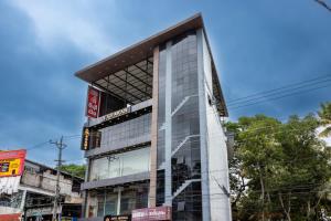 a building with a glass facade on a street at MERIDIAN BY Daan in Trivandrum