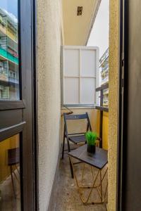 a small balcony with a table and a chair at Central Studio @ Jászai Mari Square in Budapest