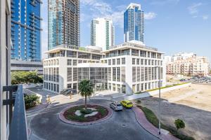 a building in a city with tall buildings at Unique Cosy &Spacious 2BR In Al Sufouh in Dubai