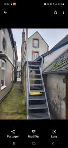 a picture of a staircase with a clock on a building at Très bel appartement cosy en hyper centre in Romorantin