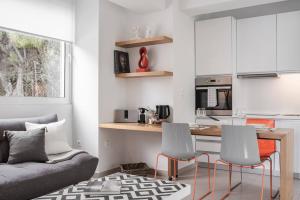 a living room with a couch and a table and chairs at Bliss Living in Vouliagmeni +38 photos