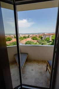 a balcony with two benches and a view of the city at Apartamentul Cetății Alba Iulia in Alba Iulia