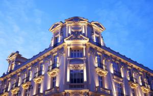 a large white building with lights on it at URSO Hotel & Spa, a Small Luxury Hotel of the World in Madrid
