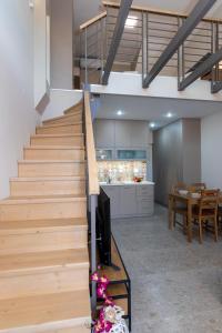 a staircase in a living room with a tv and a kitchen at Elite City Apartments & Maisonettes in Lefkada Town