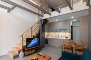 a kitchen and dining room with a staircase and a living room at Elite City Apartments & Maisonettes in Lefkada